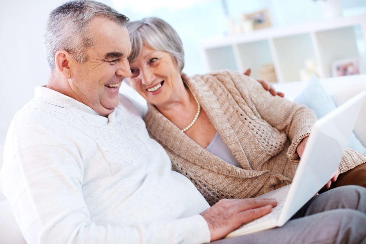Working with laptop Portrait of mature man and his wife working with laptop at home
